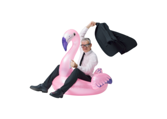 Happy businessman going on vacation and riding an inflatable flamingo