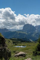 Scenic Mountain Hiking Trail with Green Hills and Rocky Cliffs