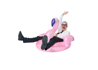 Cheerful business executive riding an inflatable flamingo