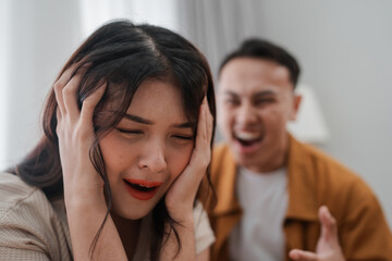 A couple is experiencing an intense and heated argument, filled with emotional distress, at home