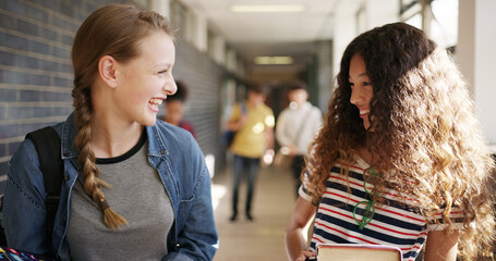 Laugh, walking and friends at high school in hallway for learning, lesson and education together. Happy, campus and teenagers in conversation, talking and chat in corridor for bonding, relax or break