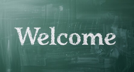 Welcome written in chalk on a green chalkboard with visible texture details.