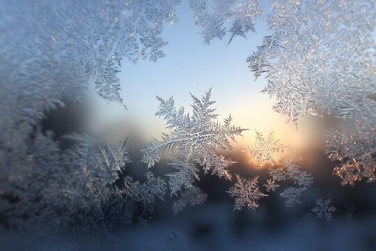 Winter frosty window with snowflake patterns and light