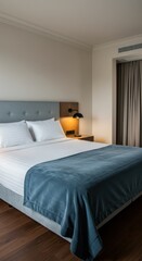 Fototapeta premium Modern hotel bedroom with a large bed and city view from the window. Luxury accommodation for travel and relaxation for guests with soft ambient light, minimalistic decor.