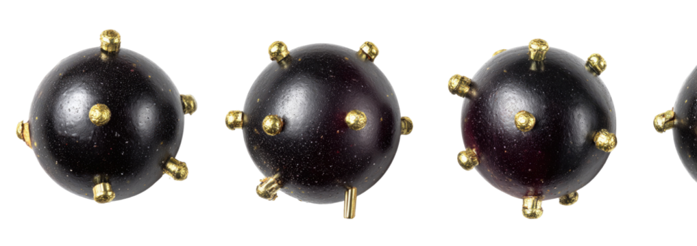 Dark, round objects with golden studs