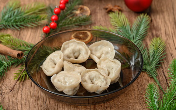A plate of Christmas Eve dumplings placed on a decorated Christmas Eve table, traditional Polish Christmas dishes