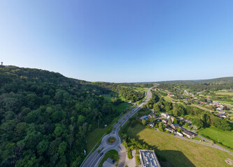 Sougne-Remouchamps, Aywaille, Liege, Wallonie, Belgium, August 10, 2025, This aerial shot showcases a roundabout amid green hills and blue skies, creating a picturesque view