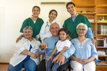 Senior man and women with grandchild feeling happy in home care with friendly caregiver team