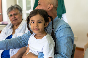 Young granddaughter visiting grandpa and grandma in homecare