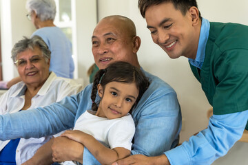 Grandpa and grandma feeling happy with young granddaughter visiting in senior homecare