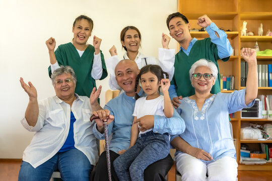 Senior man and women with grandchild feeling happy in home care with friendly caregiver team