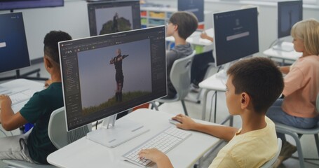 Smart Young Students Using Computers, Creating Game Characters in Design Software, Practicing 3D Modeling. Elementary School Children Learning Animation, Game Development, Digital Art. STEM Education.