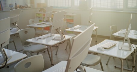 High-Tech School Computer Lab with Minimalist Furniture and PC Monitors. Modern Classroom Setup Ready for Students to Practice Coding, Design, STEM Projects and Innovative Digital Learning. Dolly Shot