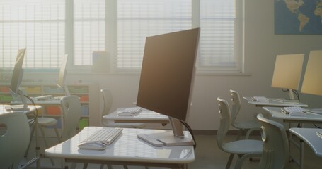 Modern Educational Space with Computer Desks, White Monitors. Computer Science Classroom Prepared for Interactive Learning, Digital Skills Training and Technology-Based School Activities. Dolly Shot.