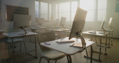 Modern Computer Classroom with White Desks, Chairs and Computer Monitors for Students. Bright Learning Environment for Digital Education, Programming Lessons, Creative 3D Design Projects. Dolly Shot.