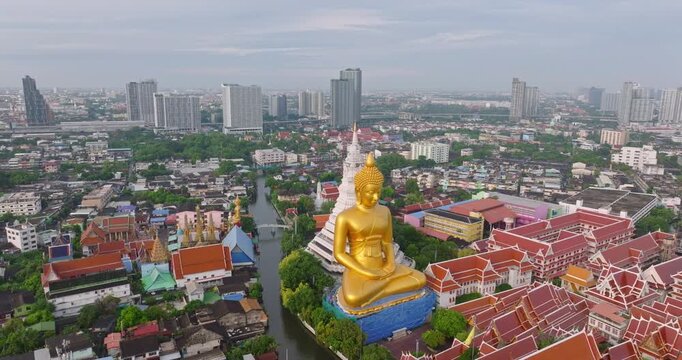 Aerial View of Wat Paknam Phasi Charoen Temple Bangkok Thailand Featuring Stunning Golden Buddha Statue Amidst Urban Landscape and Serene Surroundings