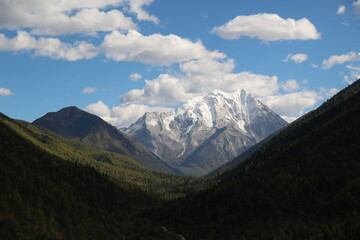 Fototapeta premium Majestic snow-capped mountain peaks pierce a clear blue sky Yala Snow Mountain Sichuan, China