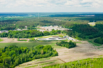 view of a modern cow farm in a deciduous forest