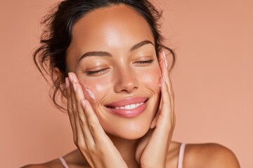 Young woman with dark hair applies skincare product while smiling in a soft-lit room during afternoon