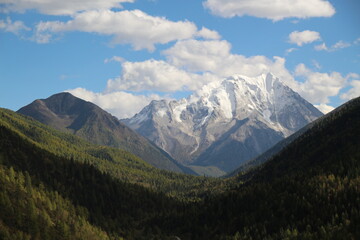 Majestic snow-capped mountain peaks pierce a clear blue sky Yala Snow Mountain Sichuan, China