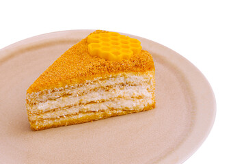 Delicious honey cake slice with honeycomb decoration on a plate