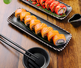Sushi platter featuring salmon rolls served with soy sauce