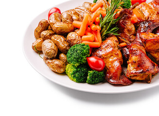 Grilled chicken with roasted potatoes and mixed vegetables served on a plate