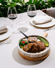 Delicious beef dish served with vegetables and sauce in elegant dining setting