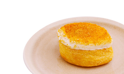 Delicious dessert treat with cream and golden topping on a plate