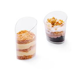 Desserts served in clear cups with layers of cream and toppings