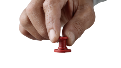 Close-up of hand placing red thumbtack, symbolizing attention and marking important points, isolated on a transparent background.