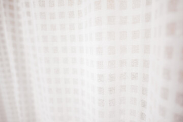 Obraz premium Textured Fabric: Close-up view of a textured white fabric, draped softly. Its intricate pattern creates a sense of depth and elegance. The image subtly evokes a sense of purity.