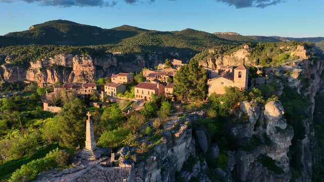 medieval mountain village of Siurana in Catalunya drone view at sunset, tourist destination in Spain, ancient cliff town drone shot, rock climbing in Siurana