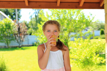 a child joyfully eating ice cream, with a backdrop of greenery. the simple pleasures of childhood.
