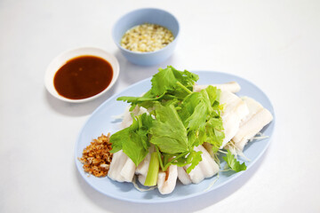 Freshly boiled fish served with dipping sauce: A traditional Thai dish featuring seafood prepared simply and enjoyed as a family meal at a restaurant.