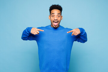 Young man of African American ethnicity wear sweatshirt casual clothes point index finger on...