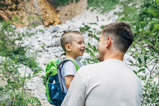 Father and son hiking outdoors enjoying communication and leisure