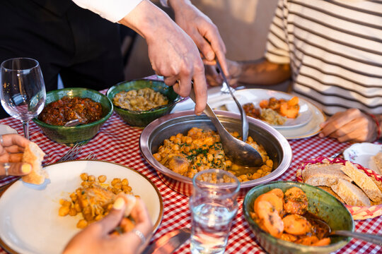 Waiter serving traditional Moroccan cuisine at restaurant table
