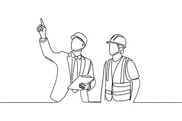 Two construction workers in hard hats discussing plans at a site