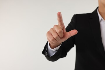 Man touching something on white background, closeup. Space for text