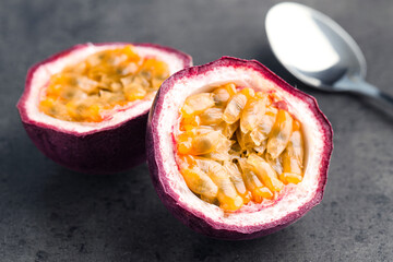 Fresh passion fruits on grey table, closeup