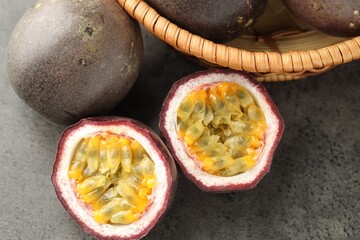 Fresh passion fruits on grey table, flat lay