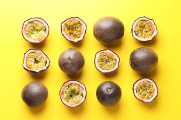 Fresh passion fruits on yellow background, flat lay