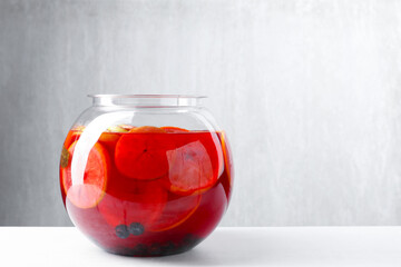 Tasty fruity punch on white table, space for text. Refreshing drink