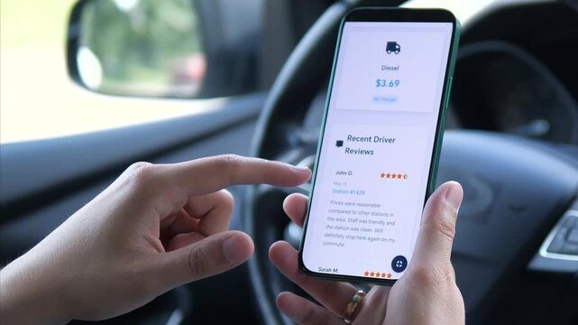 A driver's hands use a fuel price app to find the best gas prices and read station reviews, maximizing efficiency and savings. Perfect for content on budgeting, smart driving, and app utility.