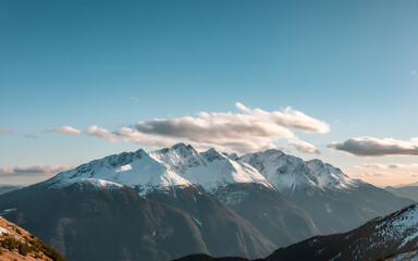 Majestic snow capped mountain peak under a cloudy sky bathed in soft sunset light majestic snow capped mountain peak under a cloudy sky bathed in soft sunset light