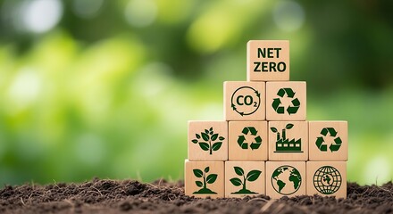 Wooden blocks with net zero and sustainability symbols on soil against green background