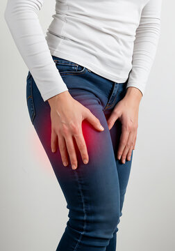 Asian Woman with Thigh Pain or Muscle Cramp &ndash; Medical Concept of Leg Twitching and Discomfort
