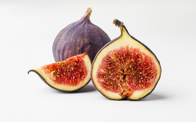 Fresh figs whole and cut on a light background. Concept of healthy eating, natural products and vegetarian food. Horizontal.