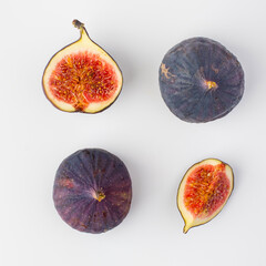 Fresh figs whole, part and cut isolated on light background. Concept of healthy eating, natural products and vegetarian food.